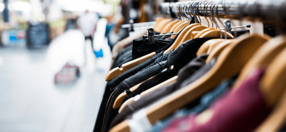 Clothes on hangers in a thrift store