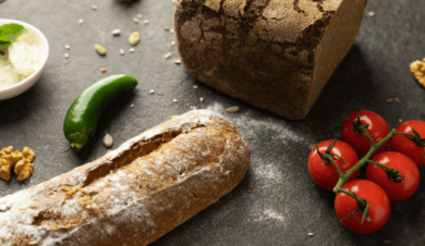 Loaf of bread and vegetables on a table